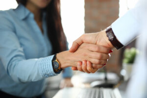 A close up of two business people shaking hands