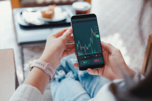 A woman checking investment performance on a phone.