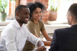 A couple talking to a financial planner.