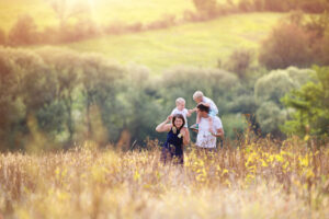 A family walking through a field in spring time.