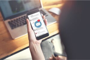 A person looking at their email on their phone.