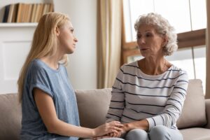 A mother and adult daughter talking.