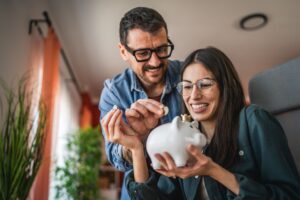 A couple saving in a piggy bank.
