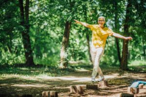 A woman doing balancing exercises outdoors.