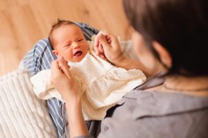 A mother holding a baby.
