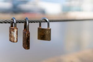 Three padlocks on a chain.