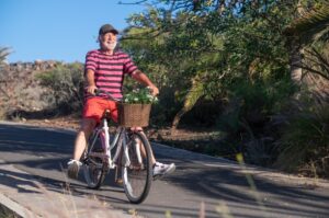 Happy senior man riding a bicycle