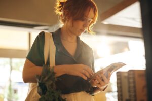 A woman examining a product label.